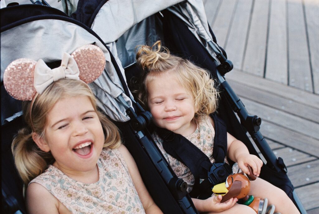 Little girls on Disney's Boardwalk sitting in stroller