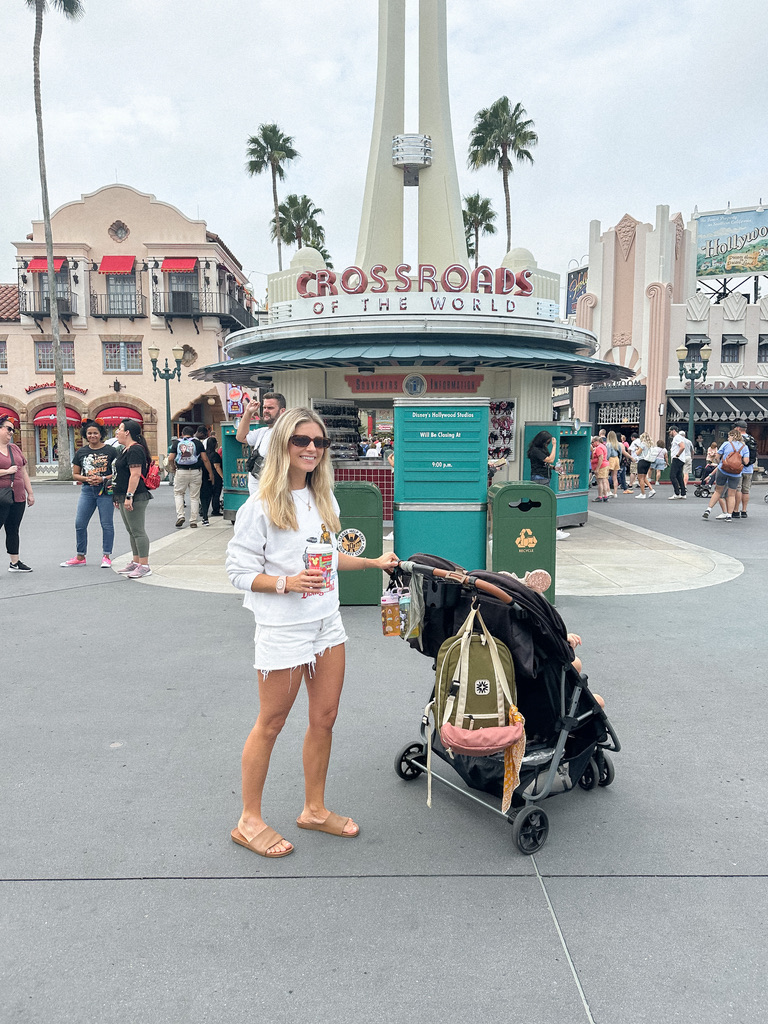 Mom in Disney's Hollywood Studios pushing Zoe Stroller Twin+ in Black